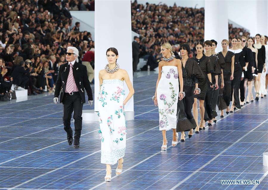 File photo taken on Oct. 2, 2012 shows Fashion designer Karl Lagerfeld (1st L) at the end of French fashion house Chanel Spring/Summer 2013 ready-to-wear fashion show at Grand Palais in Paris, France. German Fashion designer Karl Lagerfeld died in Paris at the age of 85 on Tuesday. (Xinhua/Gao Jing)