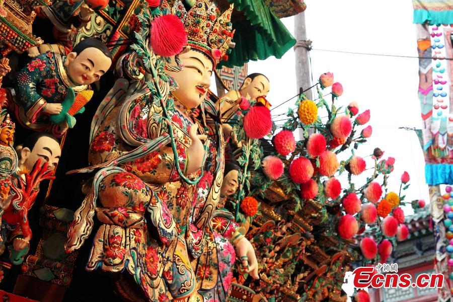 Buddha statues made of yak butter are displayed at the Ta\'er (Kumbum) Monastery in Huangzhong County, Northwest China\'s Qinghai Province, Feb. 19, 2019. Handmade by lamas in the shapes of Buddha figurines, trees, flowers, birds and animals, they are crafted at the monastery known for the most advanced butter sculpting techniques. (Photo: China News Service/Zhang Tianfu)