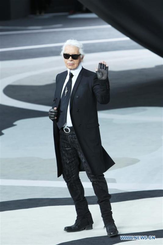 File photo taken on March 5, 2013 shows Fashion designer Karl Lagerfeld waving at the end of his Fall/Winter 2013/2014 ready-to-wear fashion show for French fashion house Chanel in Paris, France. German Fashion designer Karl Lagerfeld died in Paris at the age of 85 on Tuesday. (Xinhua/Gao Jing)