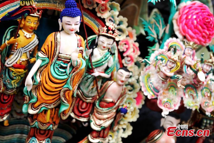 Buddha statues made of yak butter are displayed at the Ta\'er (Kumbum) Monastery in Huangzhong County, Northwest China\'s Qinghai Province, Feb. 19, 2019. Handmade by lamas in the shapes of Buddha figurines, trees, flowers, birds and animals, they are crafted at the monastery known for the most advanced butter sculpting techniques. (Photo: China News Service/Zhang Tianfu)