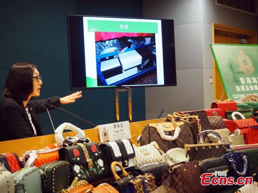 Counterfeit products, including purses and scarves, are on show at a press conference held by the Customs and Excise Department, Hong Kong, Feb. 21, 2019. The department\'s Intellectual Property Investigation Bureau has seized approximately 5,000 fake branded products in five stores and warehouses, with a market value of about three million HK dollars ($382,287), and also detained six suspects. (Photo: China News Service/Hong Shaokui)