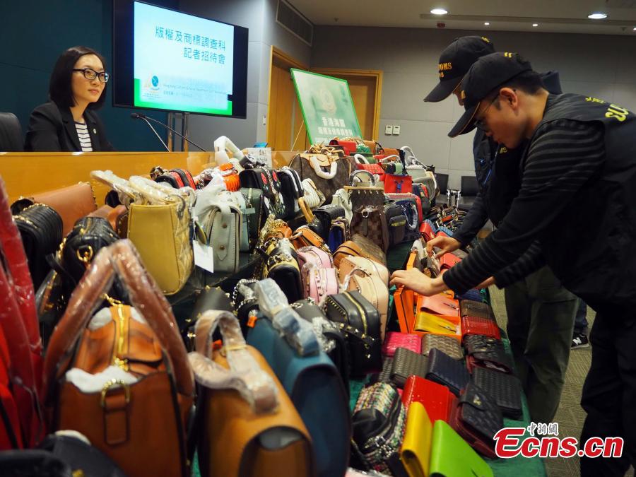 Counterfeit products, including purses and scarves, are on show at a press conference held by the Customs and Excise Department, Hong Kong, Feb. 21, 2019. The department\'s Intellectual Property Investigation Bureau has seized approximately 5,000 fake branded products in five stores and warehouses, with a market value of about three million HK dollars ($382,287), and also detained six suspects. (Photo: China News Service/Hong Shaokui)