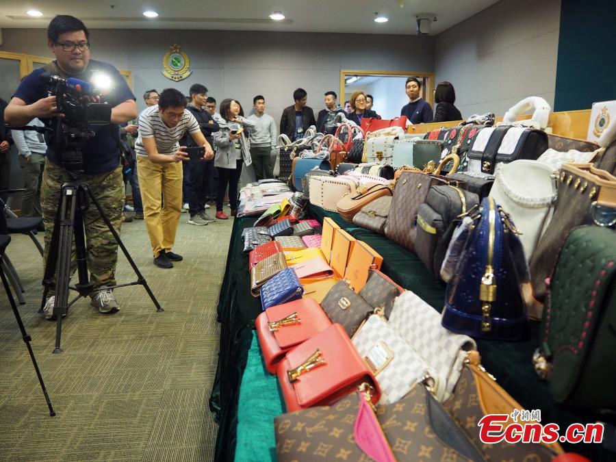 Counterfeit products, including purses and scarves, are on show at a press conference held by the Customs and Excise Department, Hong Kong, Feb. 21, 2019. The department\'s Intellectual Property Investigation Bureau has seized approximately 5,000 fake branded products in five stores and warehouses, with a market value of about three million HK dollars ($382,287), and also detained six suspects. (Photo: China News Service/Hong Shaokui)