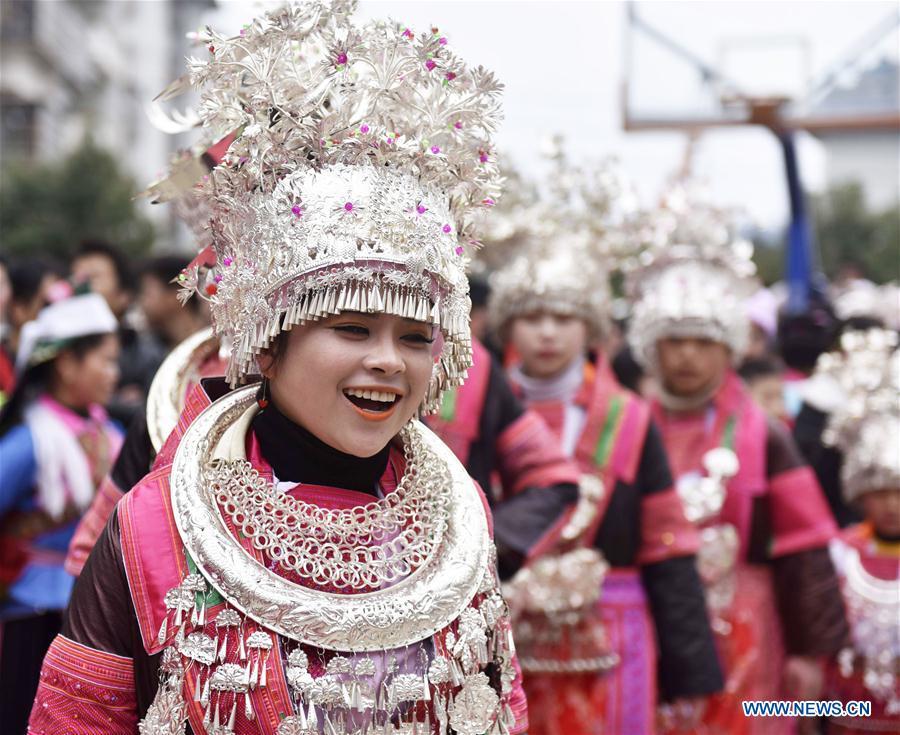 People of the Miao ethnic group dance to the Lusheng, a reed-pipe wind instrument, to celebrate their new life at the relocated Fengle community in Rongjiang County, southwest China\'s Guizhou Province, Feb. 21, 2019. The relocated ethnic Miao people from remote areas to the community held a gathering Thursday by inviting neighboring Miao villages\' Lusheng teams to celebrate their new life.(Xinhua/Jiang Zuoxian)