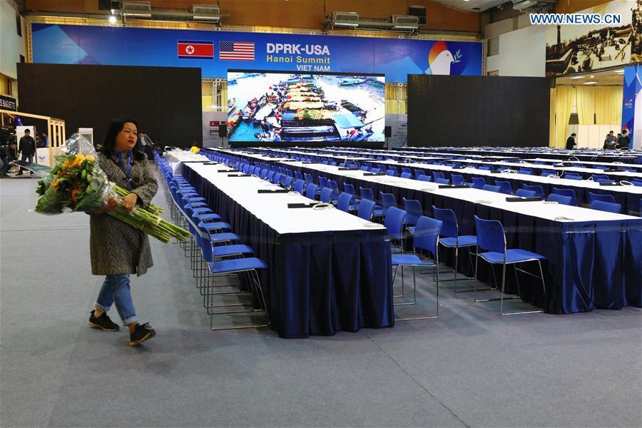 People pass by the International Media Center for the second summit between the Democratic People\'s Republic of Korea (DPRK) and the United States in Hanoi, Vietnam, on Feb. 24, 2019. The second DPRK-U.S. summit is scheduled to be held in Hanoi on Feb. 27-28. (Xinhua/Wang Di)