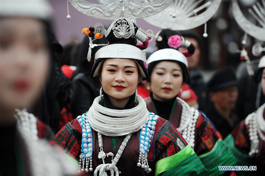 People in traditional costumes perform the lusheng dance in Zhouxi Town, Kaili City of southwest China\'s Guizhou Province, Feb. 24, 2019. The ethnic Miao girls donning traditional embroidered attire and silver ornaments sing and dance to the sound of the lusheng, a reed-pipe wind instrument, to pray for a good harvest. Ethnic Miao people get together at Gannangxiang to rejoice in the annual Gannangxiang celebration, one of the largest-scale and most primitive Miao lusheng celebrations in Guizhou Province. (Xinhua/Yang Wenbin)