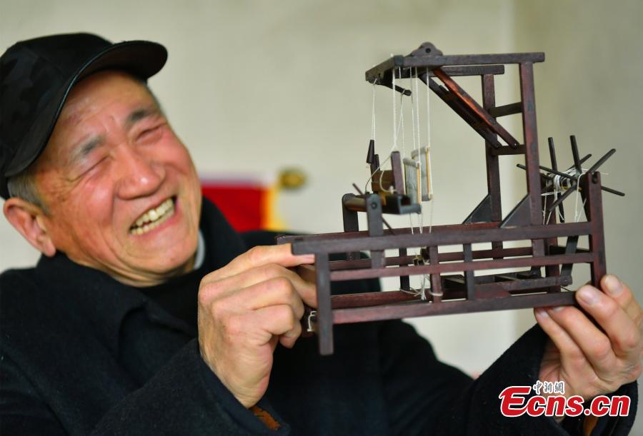 <?php echo strip_tags(addslashes(Wang Xiangcheng shows his handmade miniature agricultural tools in his home in a village in Baoding City, North China's Hebei Province, Feb. 25, 2019. Wang has built more than a dozen sets of models of old farming objects, such as ploughs, carriages, looms and stone mills, at a scale of 1:8. He said he hoped his models could provide younger generations with a glimpse of what life was like in the countryside in years past. (Photo: China News Service/Zhai Yujia))) ?>