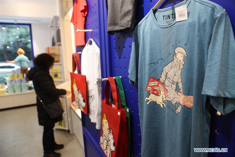 A customer chooses Tintin products at a Tintin shop in east China\'s Shanghai, Feb. 26, 2019. The Belgian comics series \