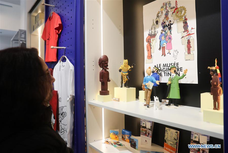 A customer chooses Tintin products at a Tintin shop in east China\'s Shanghai, Feb. 26, 2019. The Belgian comics series \