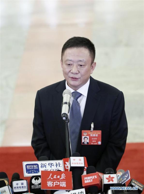 Sun Shaocheng, minister of veterans affairs, walks to receive an interview after the opening meeting of the second session of the 13th National Committee of the Chinese People\'s Political Consultative Conference (CPPCC) at the Great Hall of the People in Beijing, capital of China, March 3, 2019. (Xinhua/Shen Bohan)