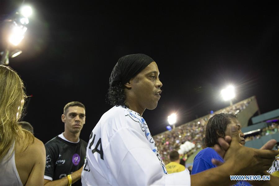 <?php echo strip_tags(addslashes(Brazil's former football player Ronaldinho (C) reacts during the parades of the Rio Carnival 2019 at the Sambadrome in Rio de Janeiro, Brazil, on March 5, 2019. The parade of special group samba school of the Rio Carnival 2019 concluded on Tuesday. (Xinhua/Li Ming))) ?>