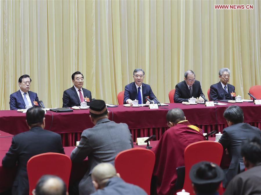 Wang Yang, a member of the Standing Committee of the Political Bureau of the Communist Party of China (CPC) Central Committee and chairman of the National Committee of the Chinese People\'s Political Consultative Conference (CPPCC), joins a panel discussion with political advisors from the religious circles at the second session of the 13th CPPCC National Committee in Beijing, capital of China, March 4, 2019. (Xinhua/Yao Dawei)