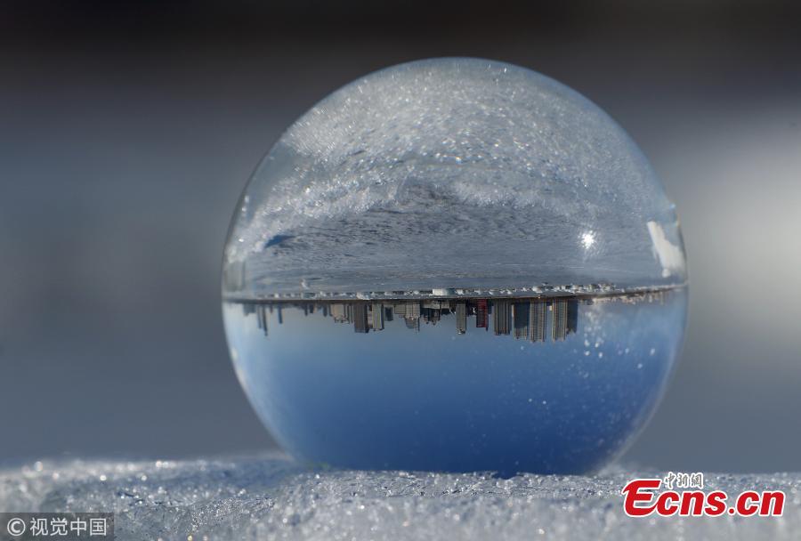 <?php echo strip_tags(addslashes(Refraction photography using a crystal ball on ice shows a view of the landscape near the Songhua River in Harbin City, Heilongjiang Province, March 4, 2019. (Photo/VCG))) ?>