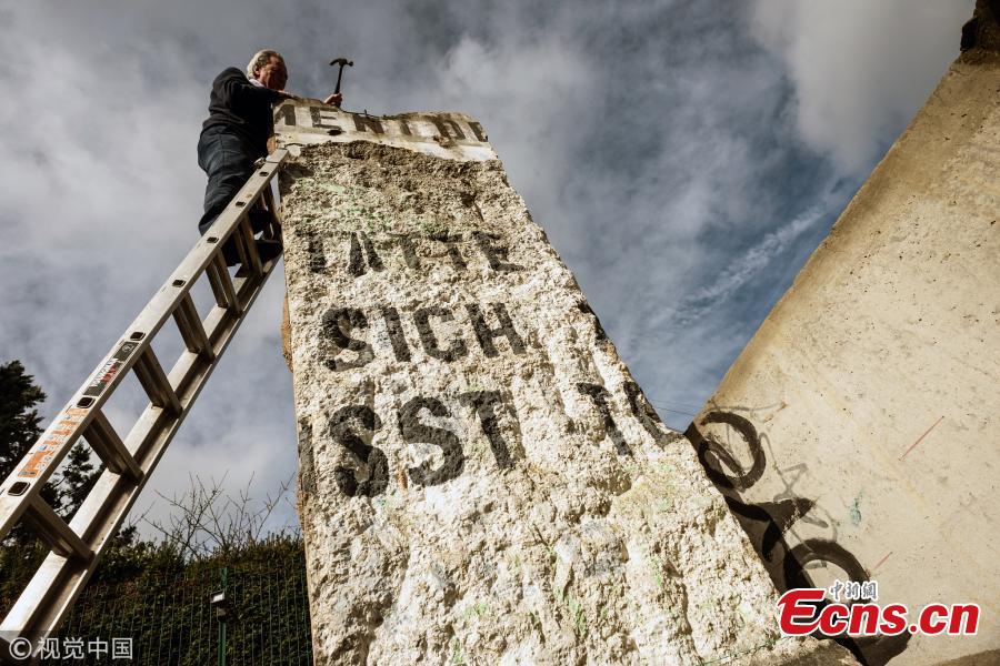 James Rylands from Summers Place Auctions with one of the sections of the Berlin Wall up for sale next Tuesday (March 12) on March 5, 2019 in Billingshurst, England. The two sections of the Berlin Wall will go under the hammer alongside a selection of Ice Age skeletons.