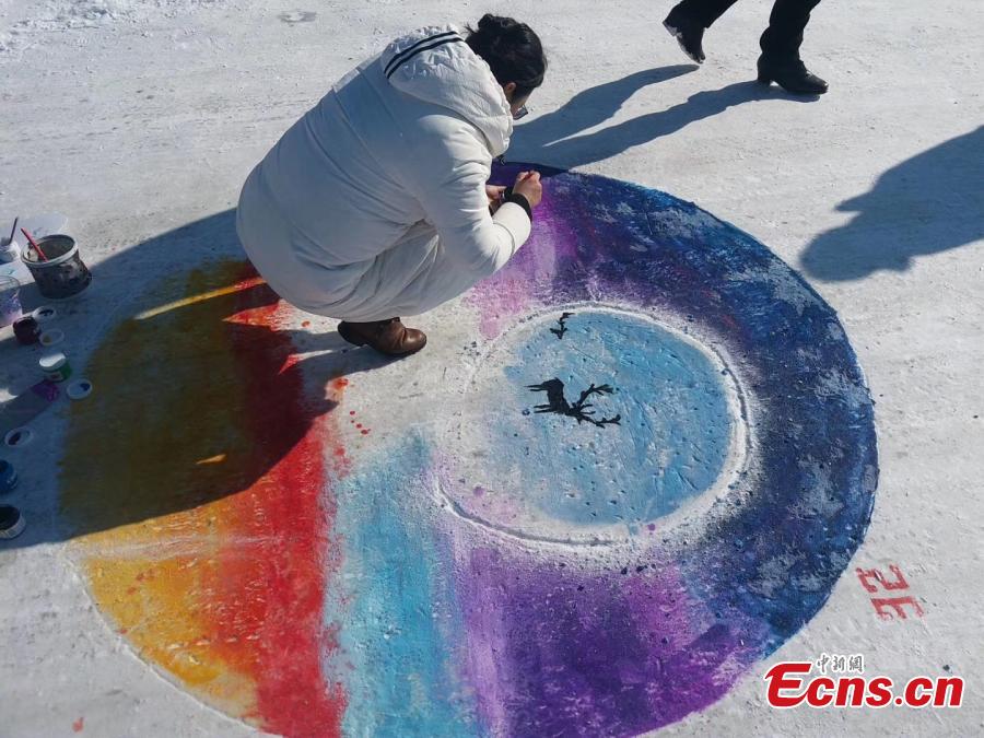 Paintings adorn the ground during an ice and snow festival in the Aoluguya Ewenki ethnic township in the Inner Mongolia Autonomous Region, March 5, 2019. The paintings depict the customs and natural landscape of the township, home to China\'s only reindeer-herding tribe. (Photo: China News Service/Zheng Wei and Deng Hongpeng)