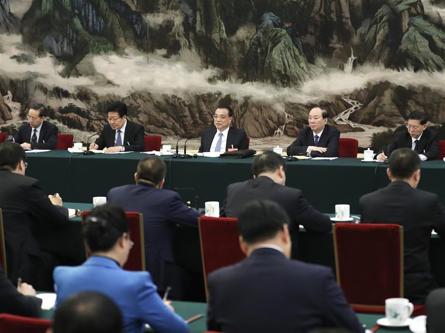 Chinese Premier Li Keqiang, also a member of the Standing Committee of the Political Bureau of the Communist Party of China (CPC) Central Committee, joins deliberation with deputies from Hubei Province at the second session of the 13th National People\'s Congress in Beijing, capital of China, March 8, 2019. (Xinhua/Ding Lin)