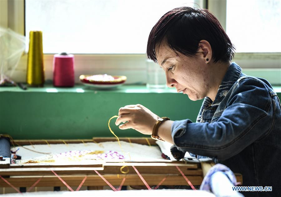 Renagul embroiders for haute couture at her workshop in Yizhou District of Hami City, northwest China\'s Xinjiang Uygur Autonomous Region, on March 8, 2019. The haute couture, literally named \