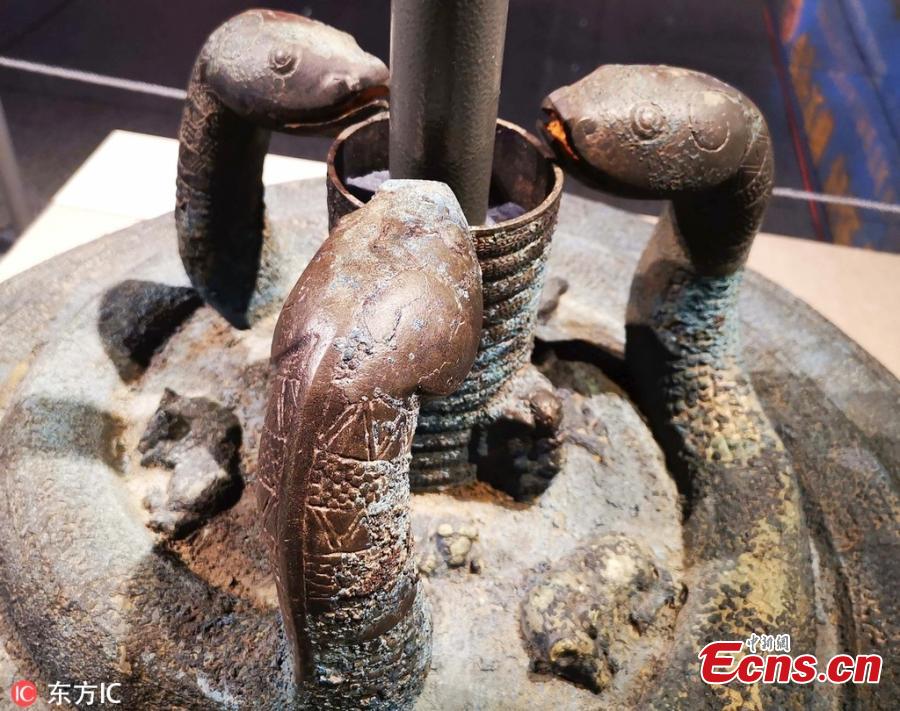 The bronze stand of a Jiangu, a large barrel drum mounted on a pole, is on display at the Shanxi Museum in Taiyuan City, Shanxi Province, March 14, 2019 as police hold an exhibition to display relics they have recovered. A first-class national cultural relic, the stand from the Warring States Period (475-221 B.C.) features three snakes and delicate images of several other animals. With a diameter of 77 centimeters and 47 centimeters tall, it weighs 80 kilograms, making it the largest and heaviest drum stand ever excavated in China. (Photo/IC)