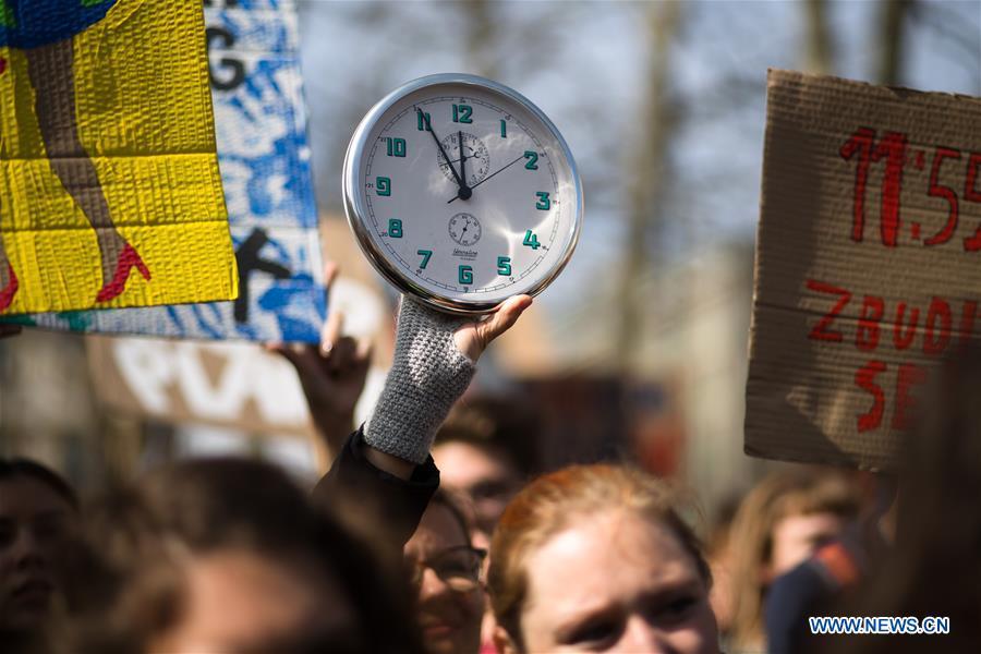 A protester holds up a clock that stands at 11:55, a symbolic high time to act, during a Youth Climate Strike in Ljubljana, Slovenia, on March 15, 2019. Around 5,000 students protested against inaction on climate change in Ljubljana, as part of a global Youth Climate Strike on Friday. (Xinhua/Luka Dakskobler)
