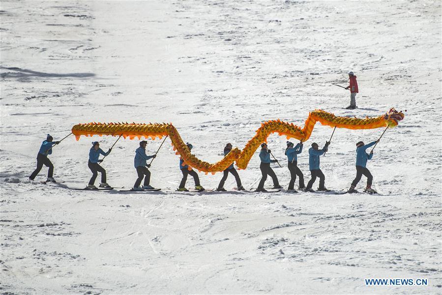 Skiers from one of the Slovenian ski school perform Chinese dragon with the blessing for the 2022 Beijing Winter Games in Kranjska Gora, Slovenia on March 16, 2019. (Xinhua/Matic Stojs Lomovsek)