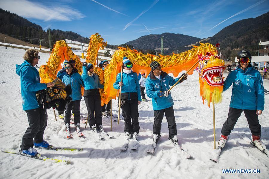Skiers from one of the Slovenian ski school perform Chinese dragon with the blessing for the 2022 Beijing Winter Games in Kranjska Gora, Slovenia on March 16, 2019. (Xinhua/Matic Stojs Lomovsek)