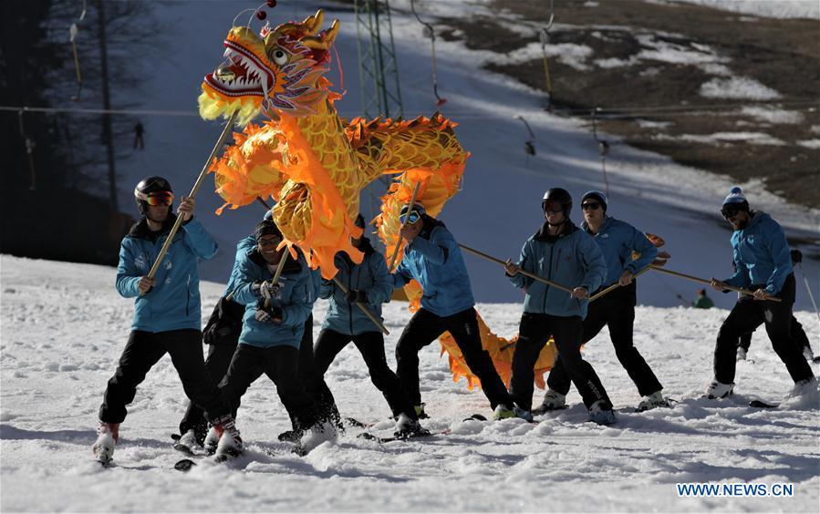 Skiers from one of the Slovenian ski school perform Chinese dragon with the blessing for the 2022 Beijing Winter Games in Kranjska Gora, Slovenia on March 16, 2019. (Xinhua/Matic Stojs Lomovsek)