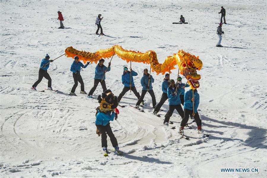 Skiers from one of the Slovenian ski school perform Chinese dragon with the blessing for the 2022 Beijing Winter Games in Kranjska Gora, Slovenia on March 16, 2019. (Xinhua/Matic Stojs Lomovsek)
