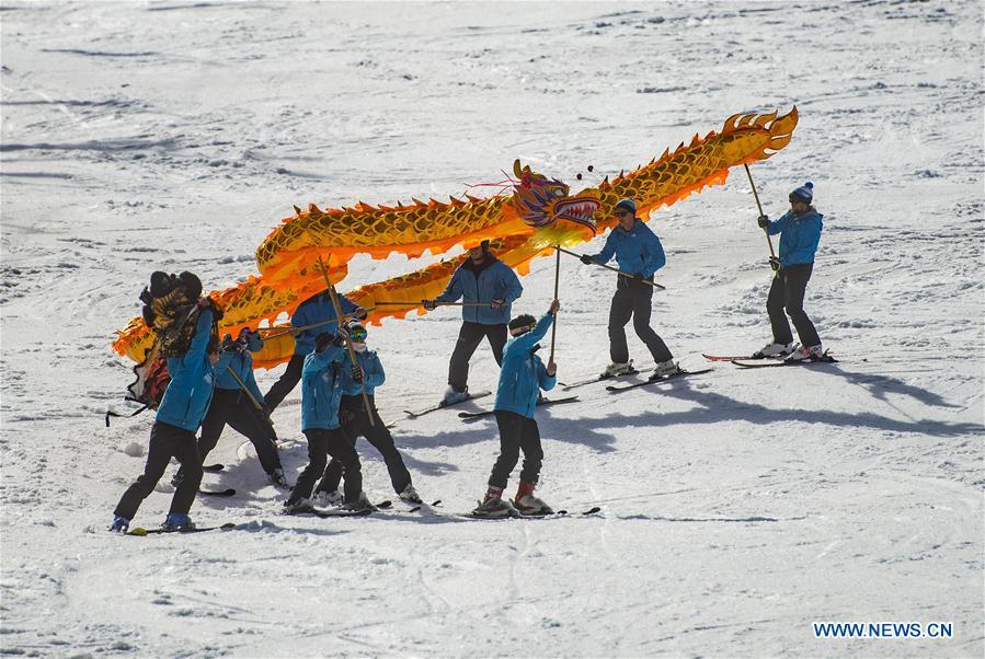Skiers from one of the Slovenian ski school perform Chinese dragon with the blessing for the 2022 Beijing Winter Games in Kranjska Gora, Slovenia on March 16, 2019. (Xinhua/Matic Stojs Lomovsek)