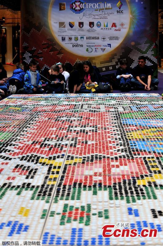 \'Bosnian qillim\' carpet made of plastic bottle caps in colors and patterns typical for Bosnian traditional wool carpet is displayed at Sarajevo City Center mall to mark the Global Recycling Day, March 18, 2019. The bottle cap carpet, made by 700 citizens of Sarajevo, covers 30 square meters of surface and was made using a total of 25,000 plastic bottle caps. (Photo/Agencies)