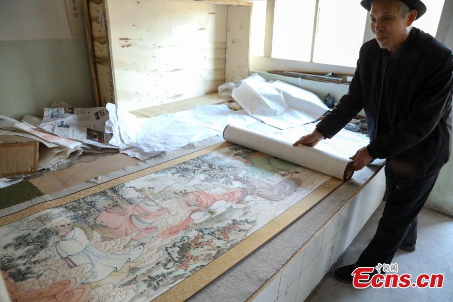 <?php echo strip_tags(addslashes(Zhang Zhanping shows his scrolls featuring a Buddhist scripture about 1,250 Arhats, a perfected person who has achieved spiritual enlightenment, in Daixian County, Xinzhou City, North China's Shanxi Province, March 18, 2019. The 66-year-old farmer, also a local folk artist specializing in the making and painting of Buddhist sculptures, said he spent eight years creating nine scrolls, each weighing five kilograms and measuring 69 centimetres in width. The total length of the scrolls measured more than 300 meters. He also said he had attempted to apply for a Guinness World Record. (Photo: China News Service/Wang Bintian))) ?>