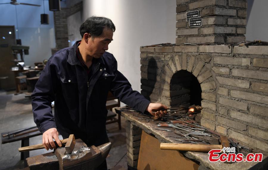 Craftsman Ding Jican makes Zhang Xiaoquan scissors using traditional methods in Hangzhou City, East China\'s Zhejiang Province, March 18, 2019. Zhang Xiaoquan scissors are a famous brand with a long history in China, and Ding has been committed to making the household utensil for 40 years. Ding himself is a master of the Zhang Xiaoquan scissor-making techniques, which have been perfected over the centuries and are recognized in China as a state intangible cultural heritage. (Photo: China News Service/Wang Gang)