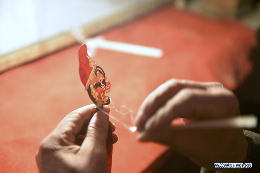 <?php echo strip_tags(addslashes(Zhang Guobin prepares for the shadow puppet performance at Luyuan Township of Weiyuan County in Dingxi City, northwest China's Gansu province, March 12, 2019. Many local folk artists concentrate on inheriting and passing down the folk art of shadow puppet performing and making in Gansu. They devote themselves to the study of the art and also organize various events to popularize the art. (Xinhua/Li Xiao))) ?>