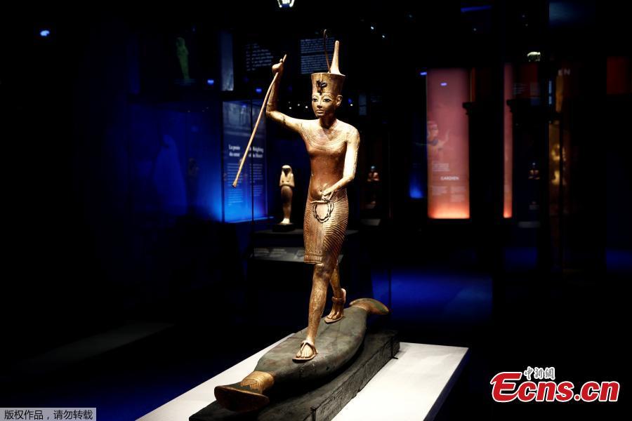 A gilded wooden figure of Tutankhamun on a skiff, throwing a harpoon, is pictured during a press visit of the Tutankhamun, Treasures of the Golden Pharaoh exhibition, displaying more than 150 original artefacts, at the Grande Halle de la Villette in Paris, France, March 21, 2019. (Photo/Agencies)