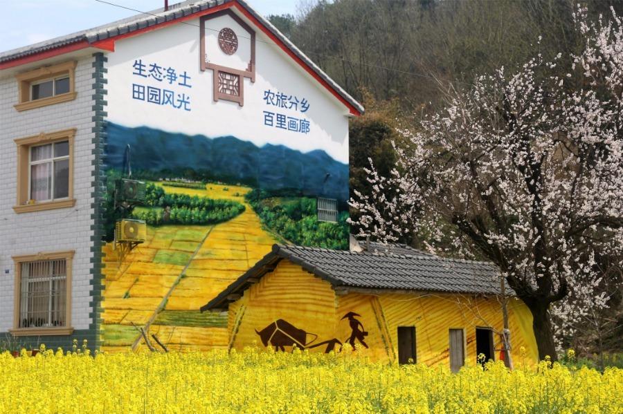 <?php echo strip_tags(addslashes(Spring brings beautiful scenery to Puxihe village in Yichang city, Hubei province, March 15, 2019. As the weather becomes warmer, golden cole flowers are blossoming in the region. Meanwhile, local residences are painted with images of animals and agricultural activities, adding liveliness to the landscape. (Photo/Asianewsphoto))) ?>