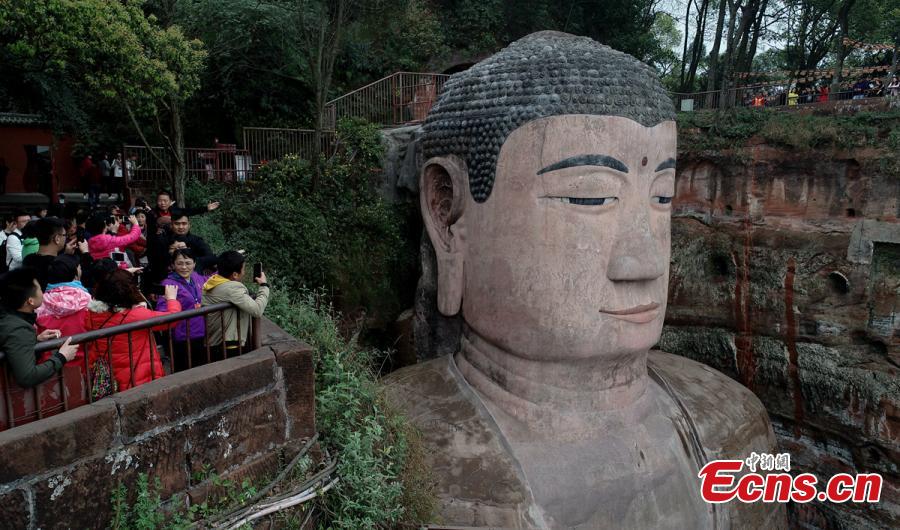 Work continues to restore the Giant Buddha of Leshan in Sichuan Province, March 25, 2019. Standing 71 meters high, the statue was carved out of a hillside in the 8th century and looks down on the confluence of three rivers. It will reopen to tourists on April 1 after undergoing repairs for the past six months. Mount Emei Scenic Area, including the Leshan Giant Buddha, was inscribed as a UNESCO world heritage site in 1996. (Photo: China News Service/Liu Zhongjun)