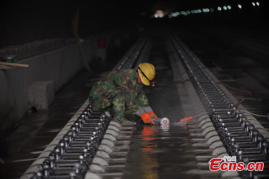 A worker inside the Nankou Tunnel, part of the Beijing-Zhangjiakou High-speed Railway in Changping District, Beijing, March 28, 2019. Construction of the main structure of the tunnel is now complete. The tunnel is 3,032 meters long and has a designed speed of 250 kilometres per hour. The 174-km-long railway is a major transportation project for the 2022 Winter Olympic Games. (Photo: China News Service/Jia Tianyong)