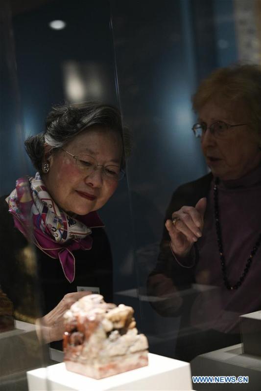 People view the displayed Seal of Empress Dowager Cixi at the exhibition titled \