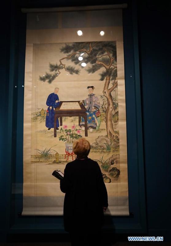 A visitor views a traditional Chinese painting at the exhibition titled \