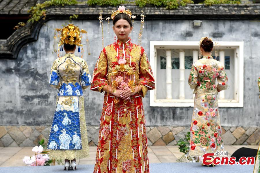 A wedding dress show held at the Three Lanes and Seven Alleys, a well-preserved architectural complex from the Ming and Qing dynasties in Fuzhou City, Fujian Province, March 31, 2019. Models from China and other countries presented wedding dresses that feature cultural traditions. (Photo: China News Service/Lyu Ming)