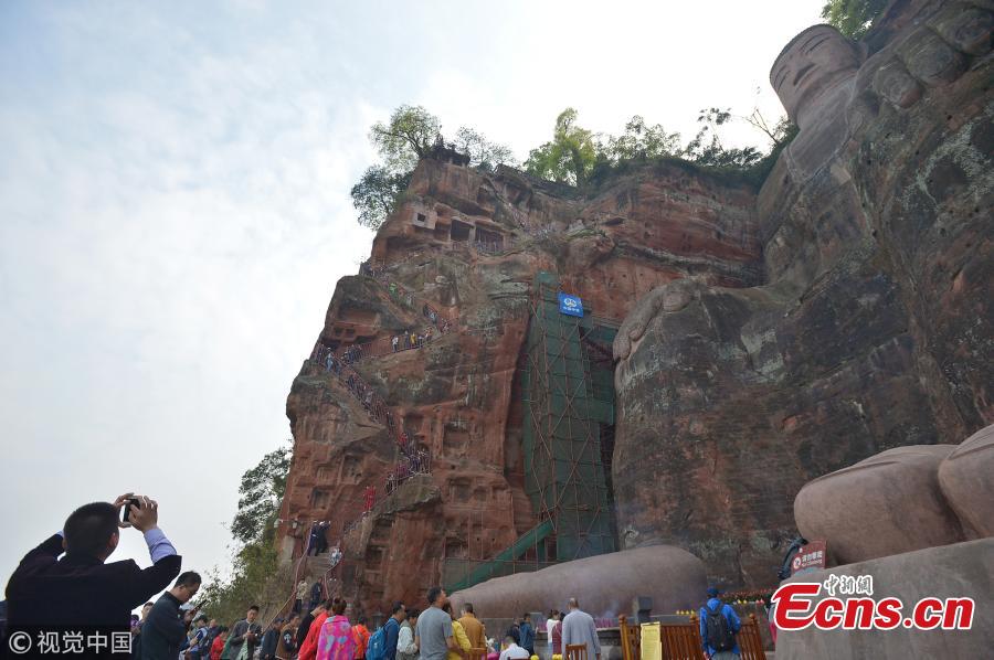 <?php echo strip_tags(addslashes(The Jiuqu Zhandao (Nine Bends Plank Road) reopens to tourists at the Leshan Giant Buddha, a UNESCO world heritage site, April 1, 2019. Sixty centimetres at its most narrow and just under one-and-a-half meters at its widest point, the path has 217 steps that wind along a cliff. Standing 71 meters high, the statue was carved out of a hillside in the 8th century and looks down on the confluence of three rivers. (Photo/VCG）)) ?>