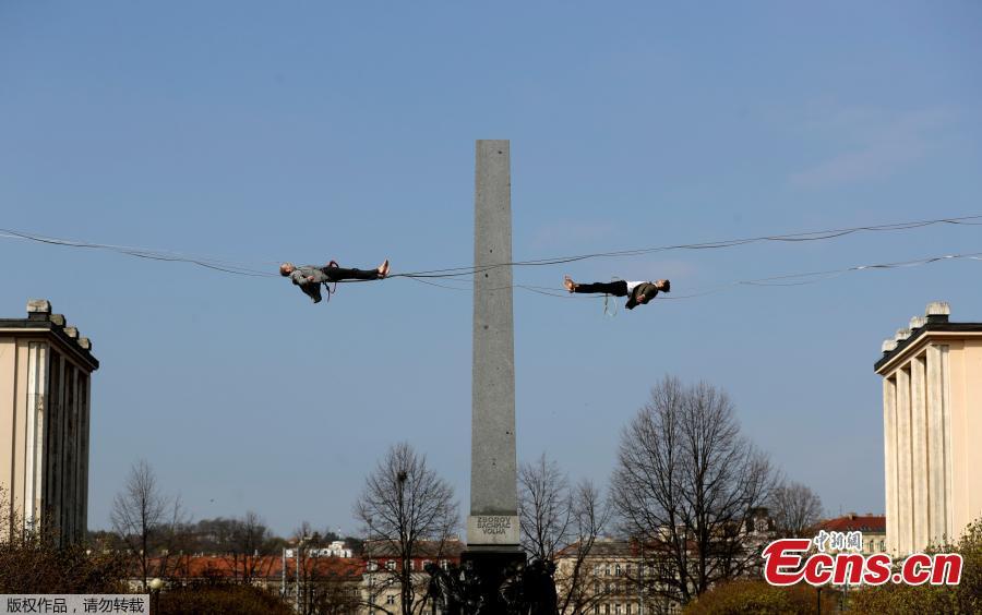 Tightrope artists balance on a rope in front of the Emmaus Monastery on the sidelines of a press conference by the Czech Minister of Health, supporting people with mental illness, on April 1, 2019 in Prague, Czech Republic.  (Photo/Agencies)