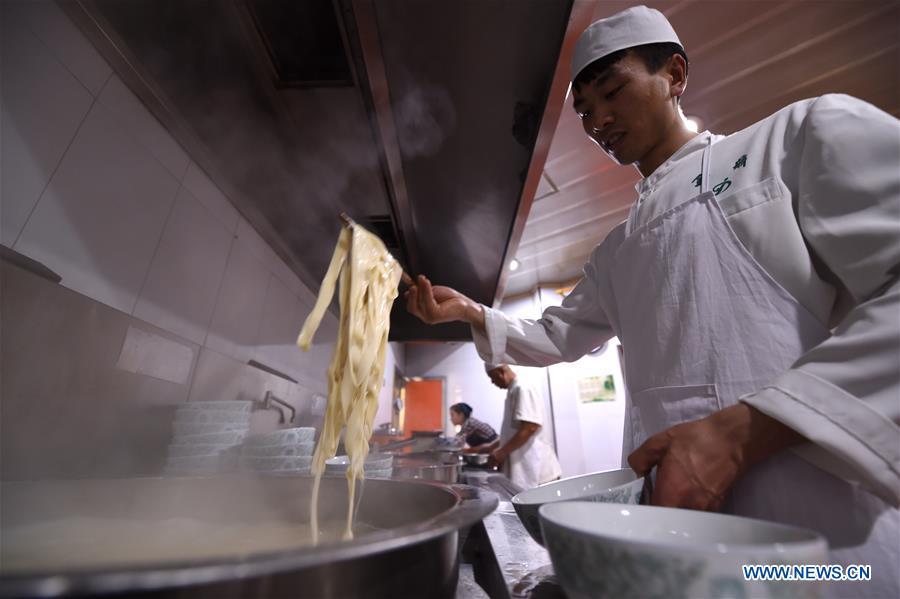 <?php echo strip_tags(addslashes(A chef gets noodles from a pot at a beef noodle restaurant in Lanzhou, capital of northwest China's Gansu Province, April 2, 2019. Lanzhou beef noodles, a Chinese hand-pulled noodle originated in Lanzhou, has a history of about 100 years. There are about ten types of noodles of different width and shapes, depending on noodle chefs' pulling skills. It has won fame both at home and abroad with its speciality of noodles and soup recipe. (Xinhua/Fan Peishen))) ?>