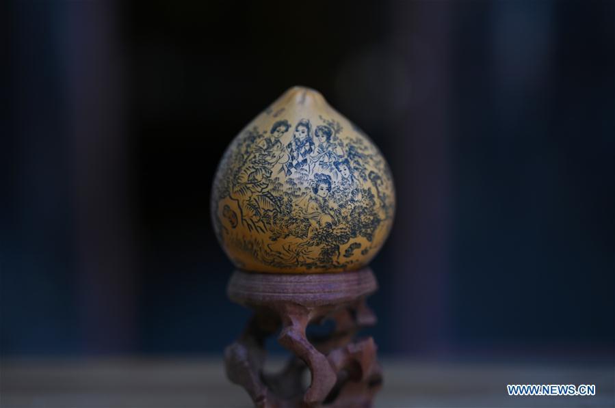 Photo taken on March 31, 2019 shows a carved gourd named \