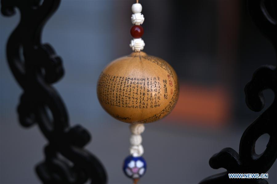Photo taken on March 31, 2019 shows a carved gourd named \