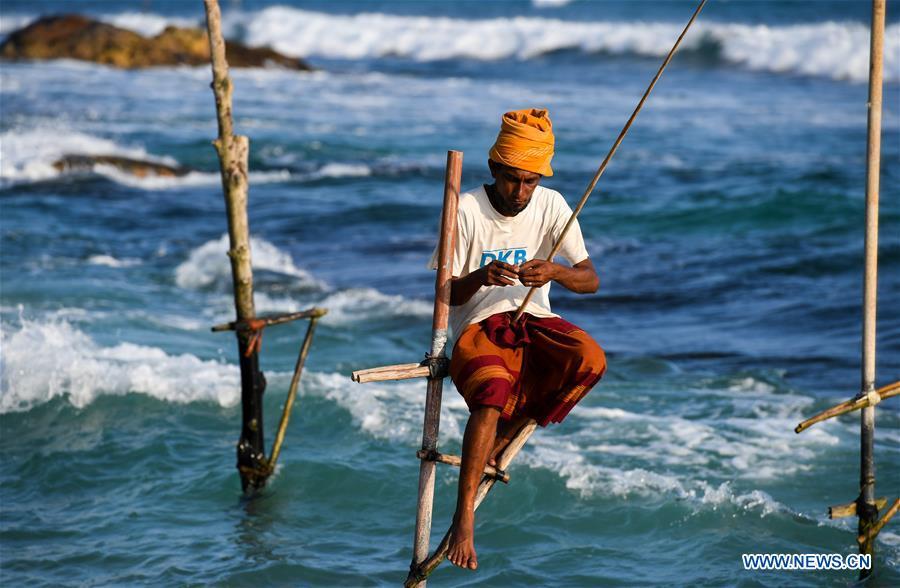 Stilt fishermen are seen at a beach in Galle, Sri Lanka, April 7, 2019. Stilt fishing is a method of fishing unique to the island country of Sri Lanka. Local fishermen sit on a crossbar called \