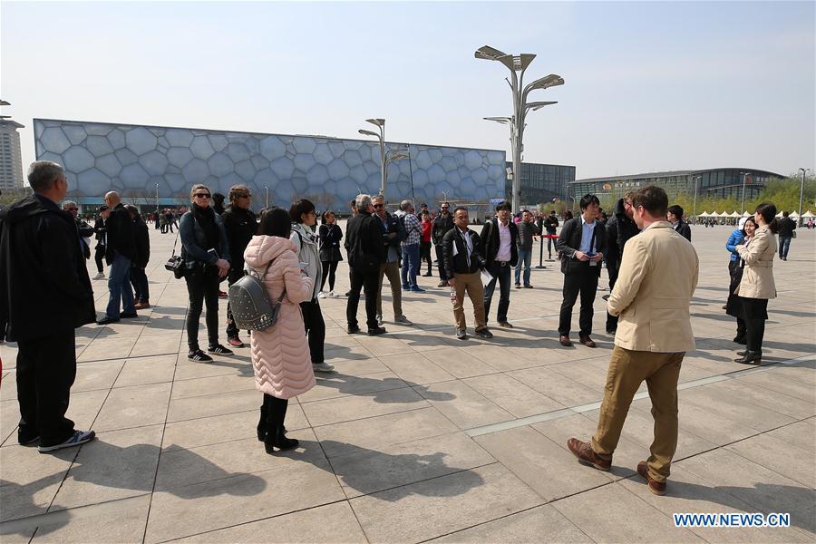 Photo taken on April 8, 2019 shows representatives from major world news agencies on the Olympic Green in front of the National Aquatics Center during a venue visit prior to the first World Agency Meeting of Beijing 2022, in Beijing, capital of China. Representatives from major world news agencies are visiting Beijing for a first look at some of the facilities to be used at the 2022 Winter Olympic Games. (Xinhua/Xu Zijian)