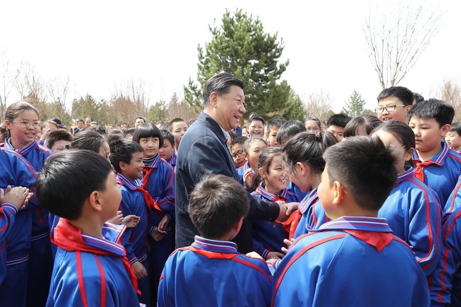 Chinese President Xi Jinping, also general secretary of the Communist Party of China Central Committee and chairman of the Central Military Commission, talks with school children as he attends a tree-planting activity in Tongzhou District in Beijing, capital of China, April 8, 2019. Other Party and state leaders, including Li Zhanshu, Wang Yang, Wang Huning, Zhao Leji, Han Zheng and Wang Qishan, also attended the activity. (Xinhua/Ju Peng)