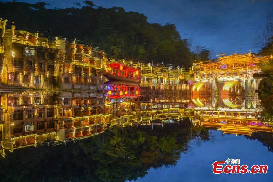 <?php echo strip_tags(addslashes(Illuminated buildings are reflected in the Tuojiang River in Fenghuang Ancient Town, Hunan Province, April 11, 2019. The old town is famous for its time-honored buildings and cultural relics, attracting large numbers of visitors each year from China and abroad. (Photo: China News Service/Yang Huafeng))) ?>