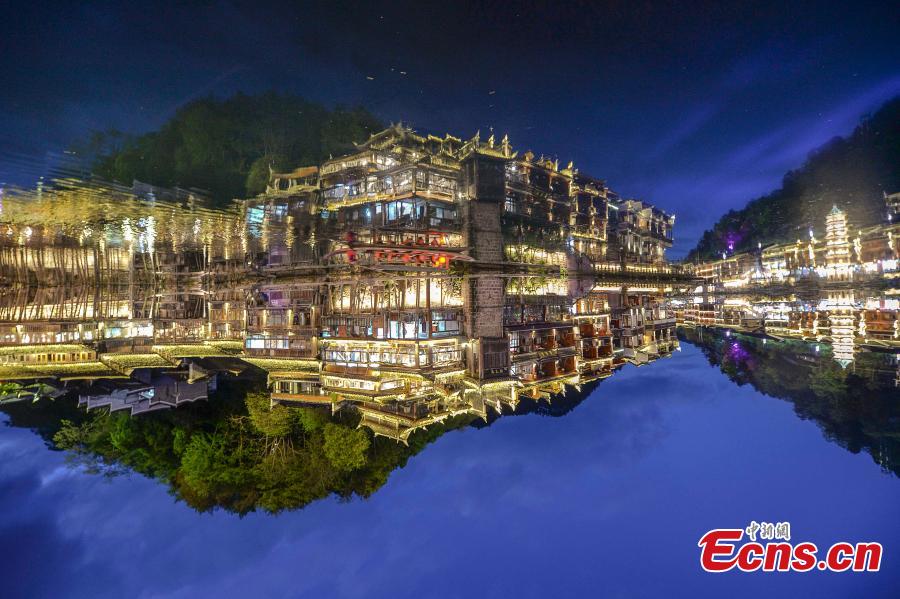 <?php echo strip_tags(addslashes(Illuminated buildings are reflected in the Tuojiang River in Fenghuang Ancient Town, Hunan Province, April 11, 2019. The old town is famous for its time-honored buildings and cultural relics, attracting large numbers of visitors each year from China and abroad. (Photo: China News Service/Yang Huafeng))) ?>