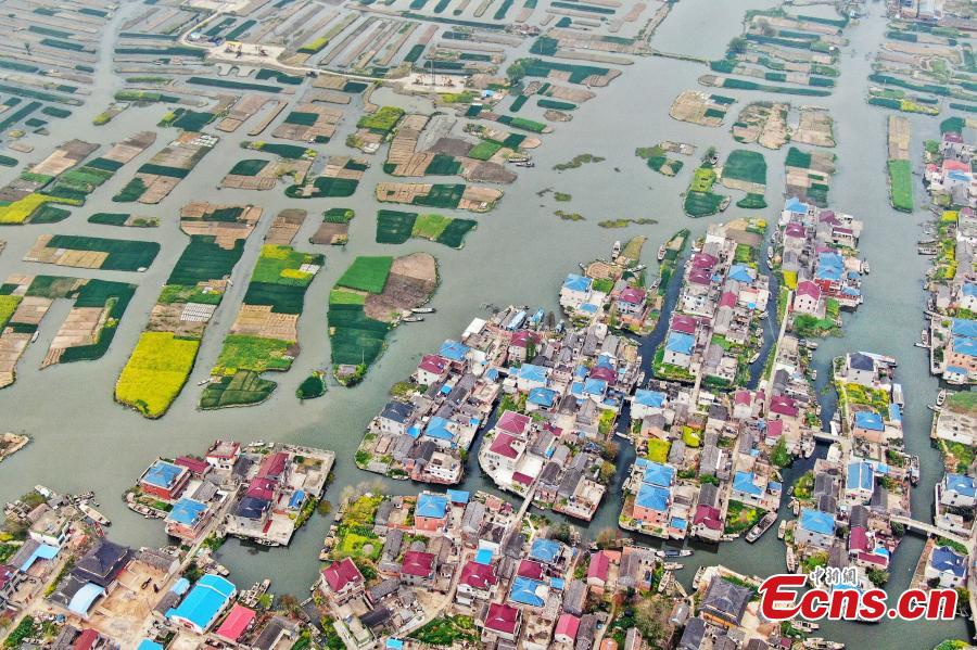 An aerial view of colorful fields crisscrossed by water in a rural area in Xinghua City, East China\'s Jiangsu Province, April 10, 2019. Locals have a tradition of digging mud from trenches or small rivers to form small plots of land. (Photo: China News Service/Yang Bo)